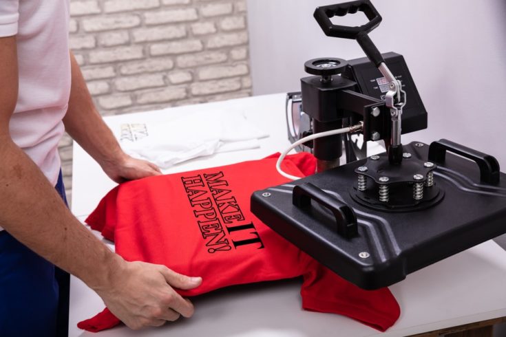 Man-printing-on-t-shirt-in-workshop-e1578271223263